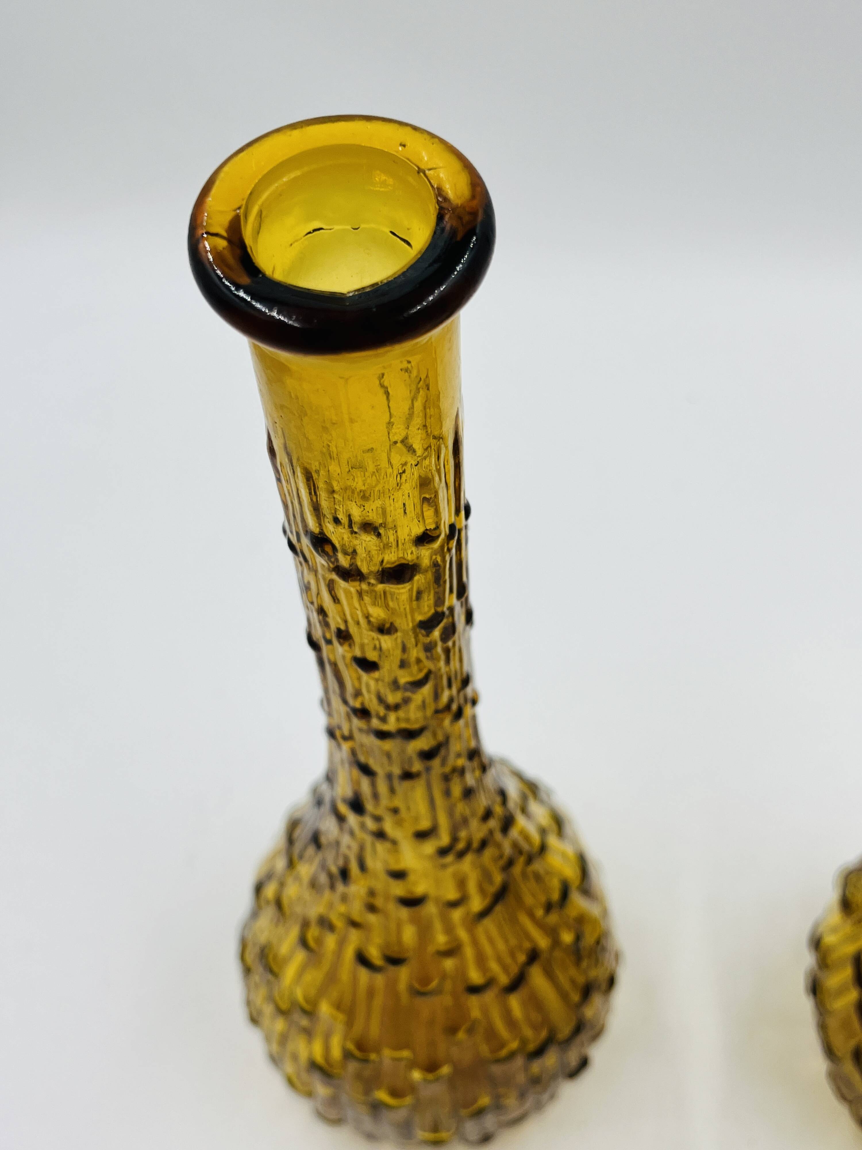 Set of two vintage textured amber glass Empoli bottles.