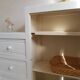 Old white asymmetrical chest of drawers