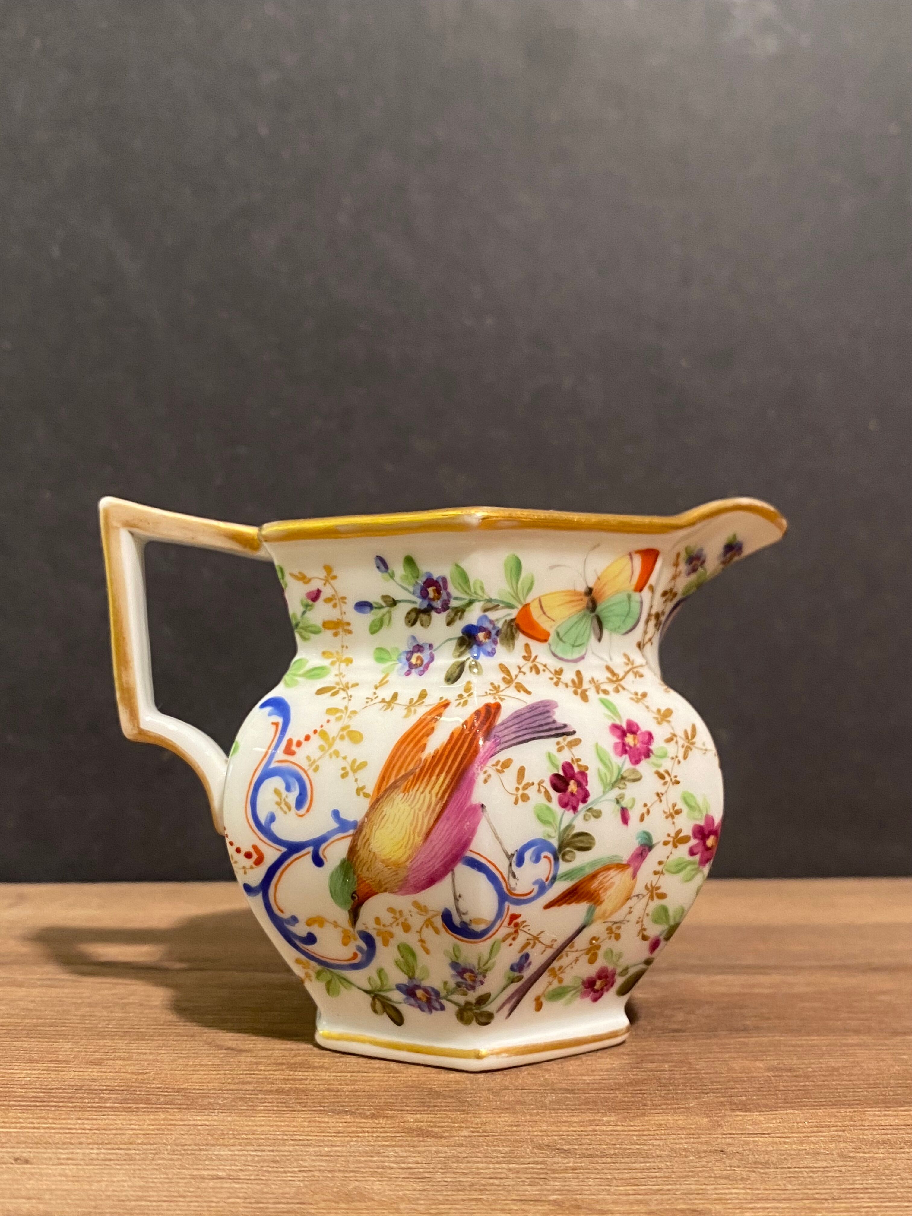 Old Paris porcelain milk jug with polychrome and gold bird floral decoration