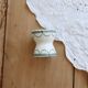Old diabolo egg cup, ironstone with ivory and green pattern.