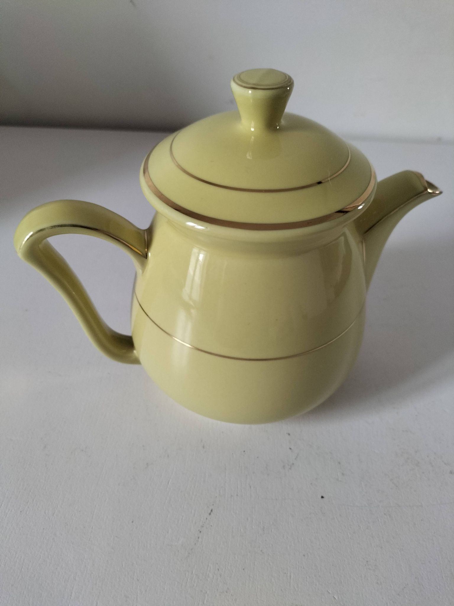 Vintage teapot in pastel yellow earthenware with gold trim