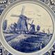 Delft Blue earthenware plate with a mill by a river decoration