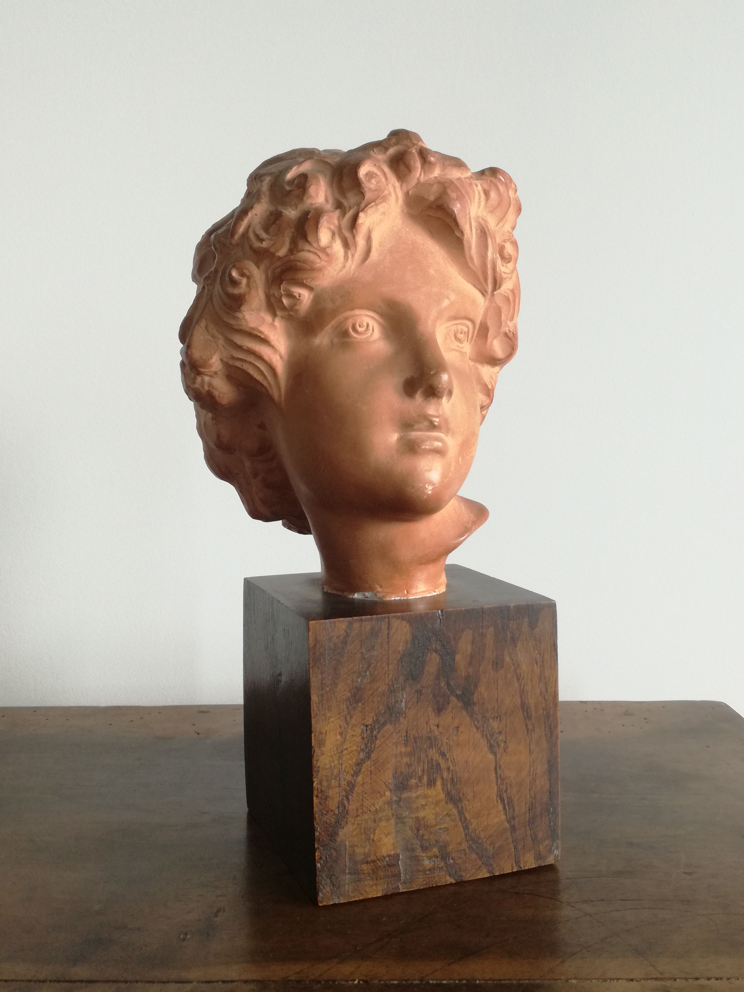 Ancient cherub bust on pedestal