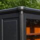 Renovated black antique Louis XVI style display cabinet, glass-fronted bookcase.