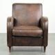 Comfortable sheepskin armchair with matching piping and a timeless look