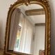 Miroir décoratif avec moulures et fronton.
