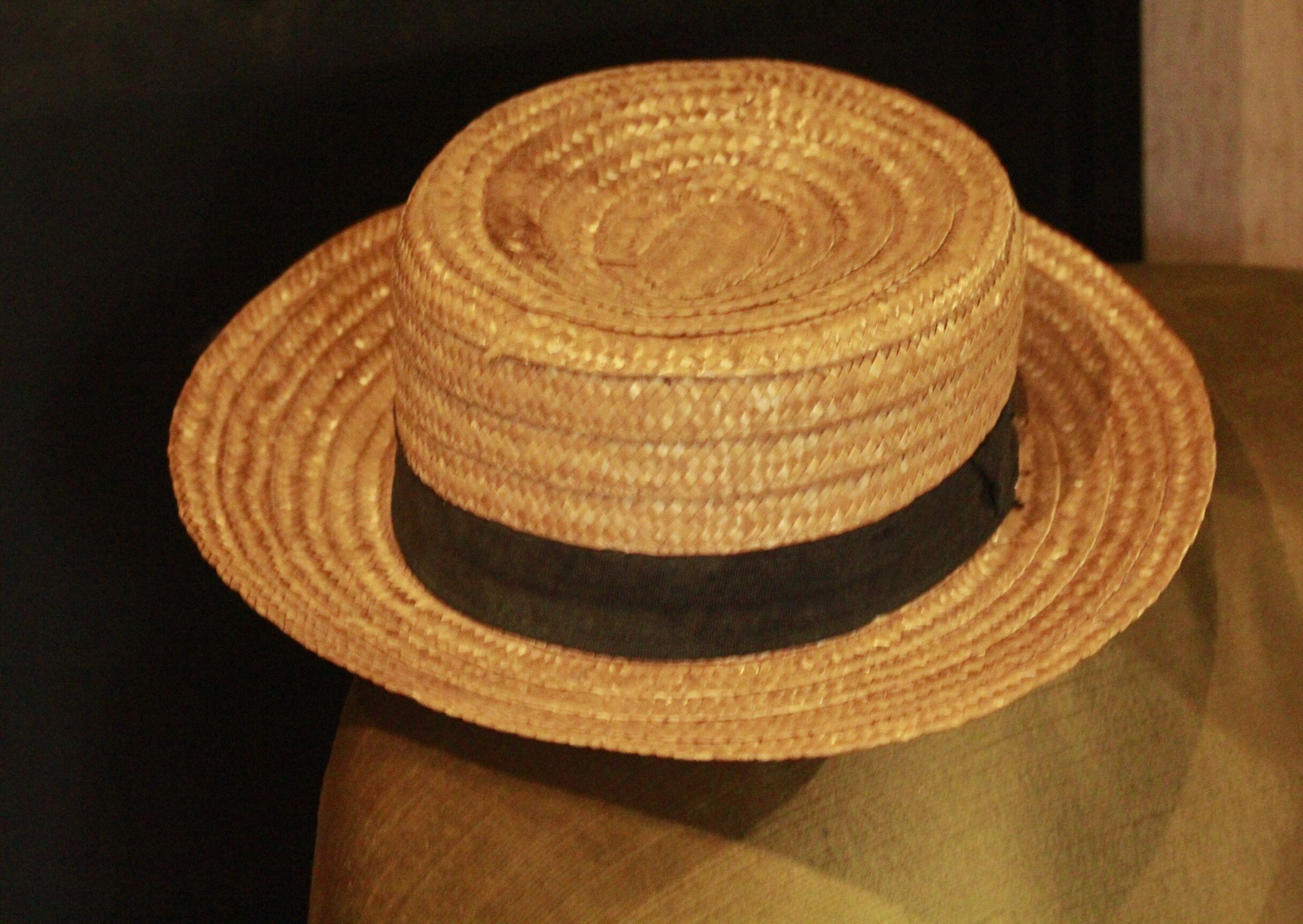 Old straw hat with black ribbon