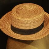 Old straw hat with black ribbon