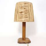 Lamp base in saddle stitched leather and raffia lampshade.