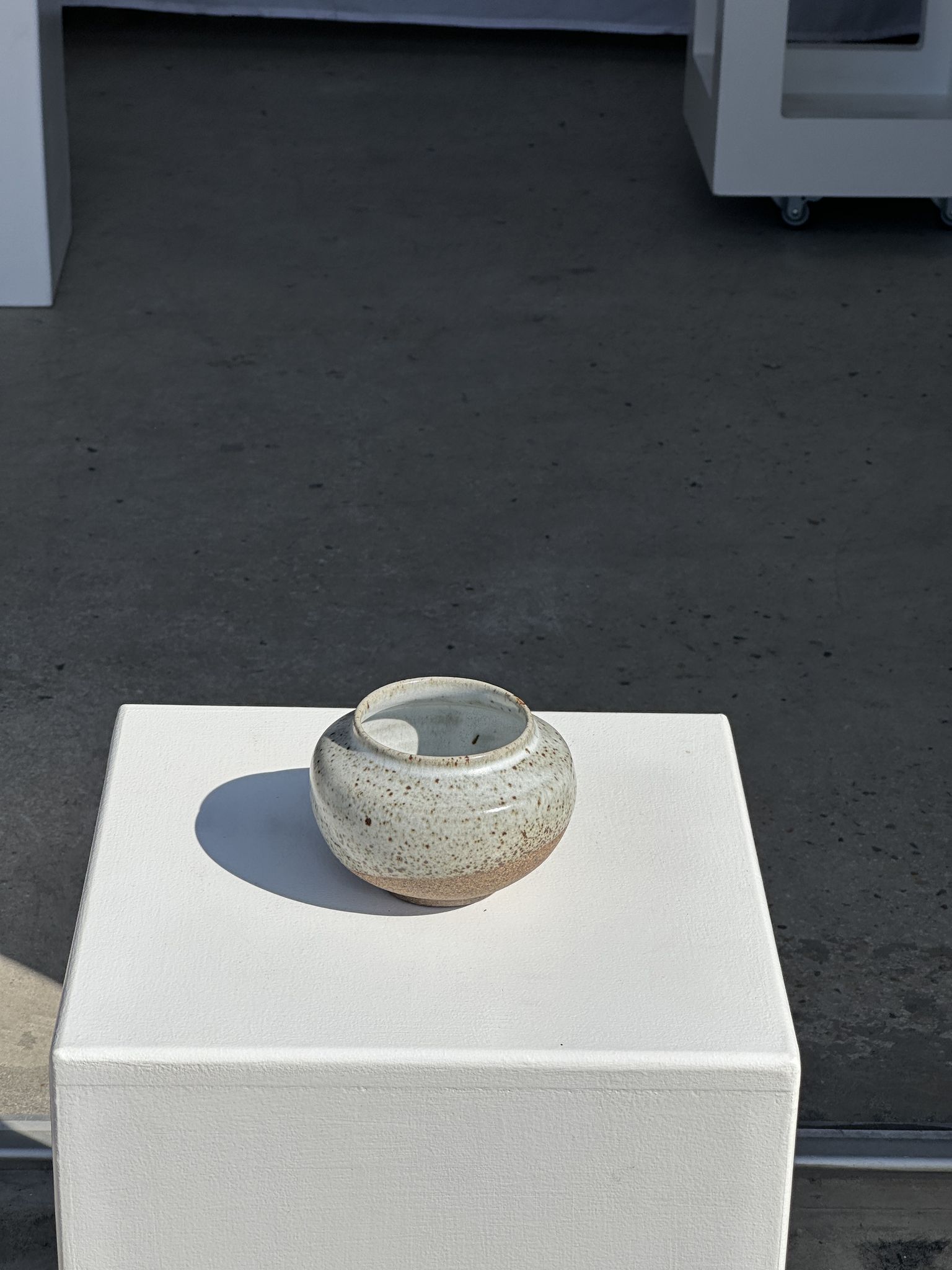 Small white ball vase tight neck in glazed speckled ceramic