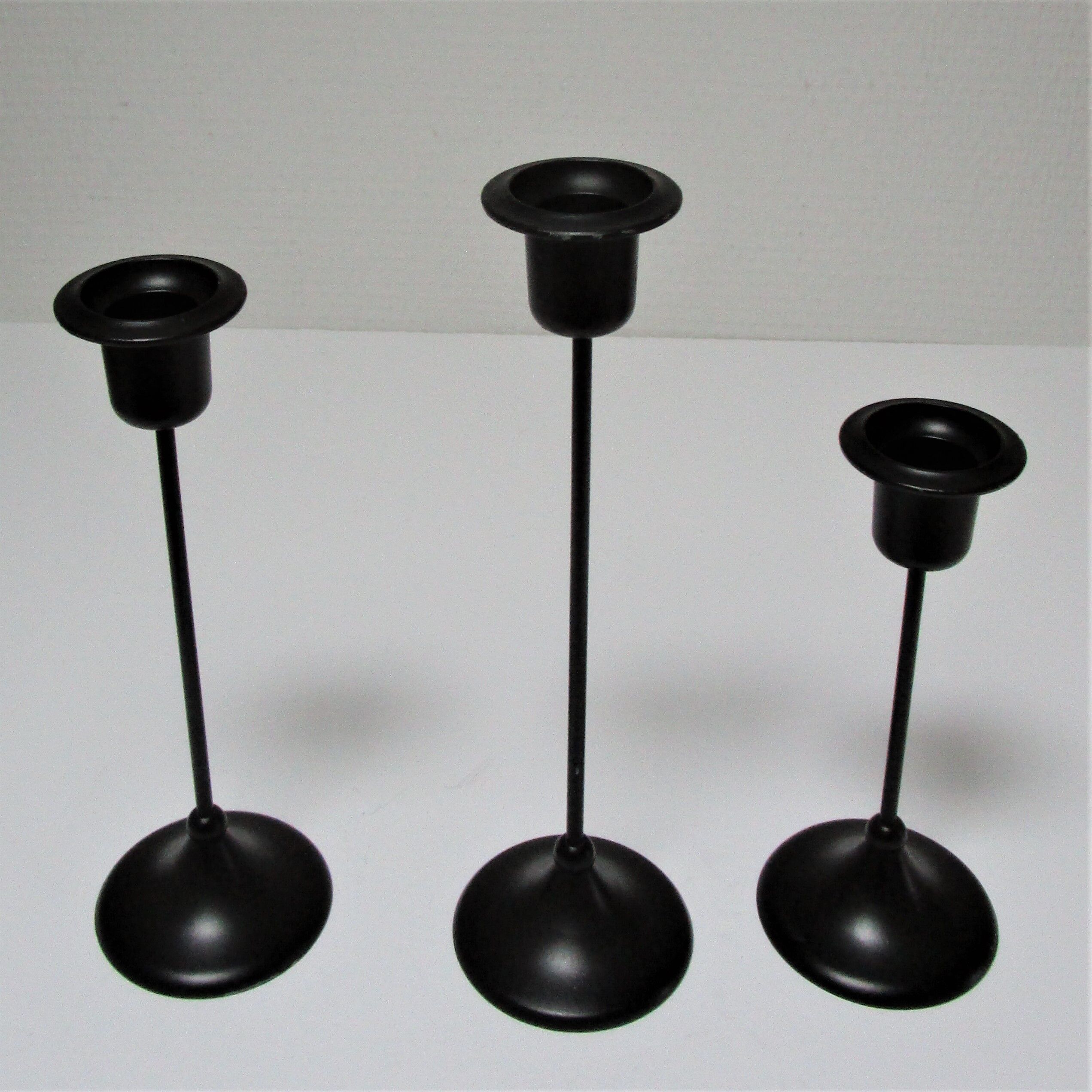 Three Scandinavian black lacquered metal candle holders