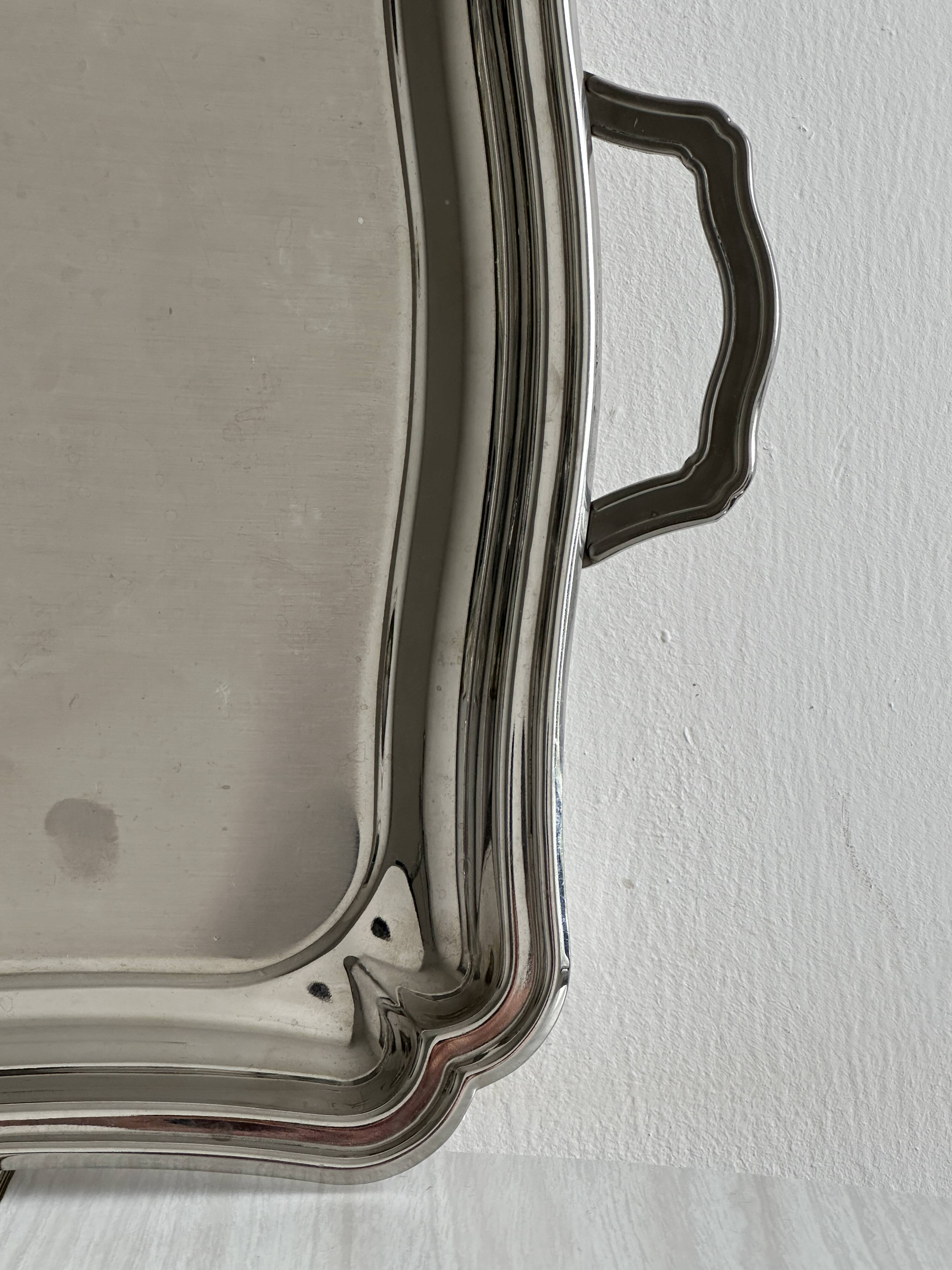 Large shiny metal serving tray