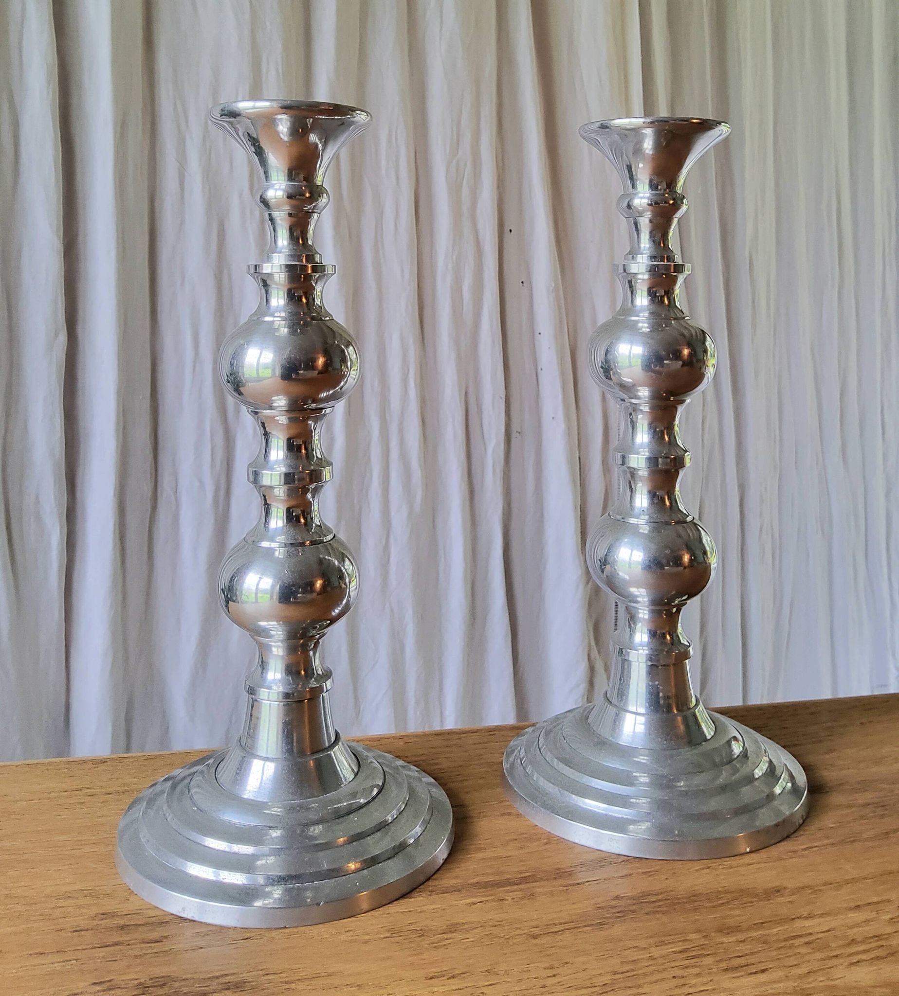 Pair of antique chrome metal candlesticks