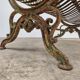 Cast iron garden bench from the late 19th century with slatted backrest.