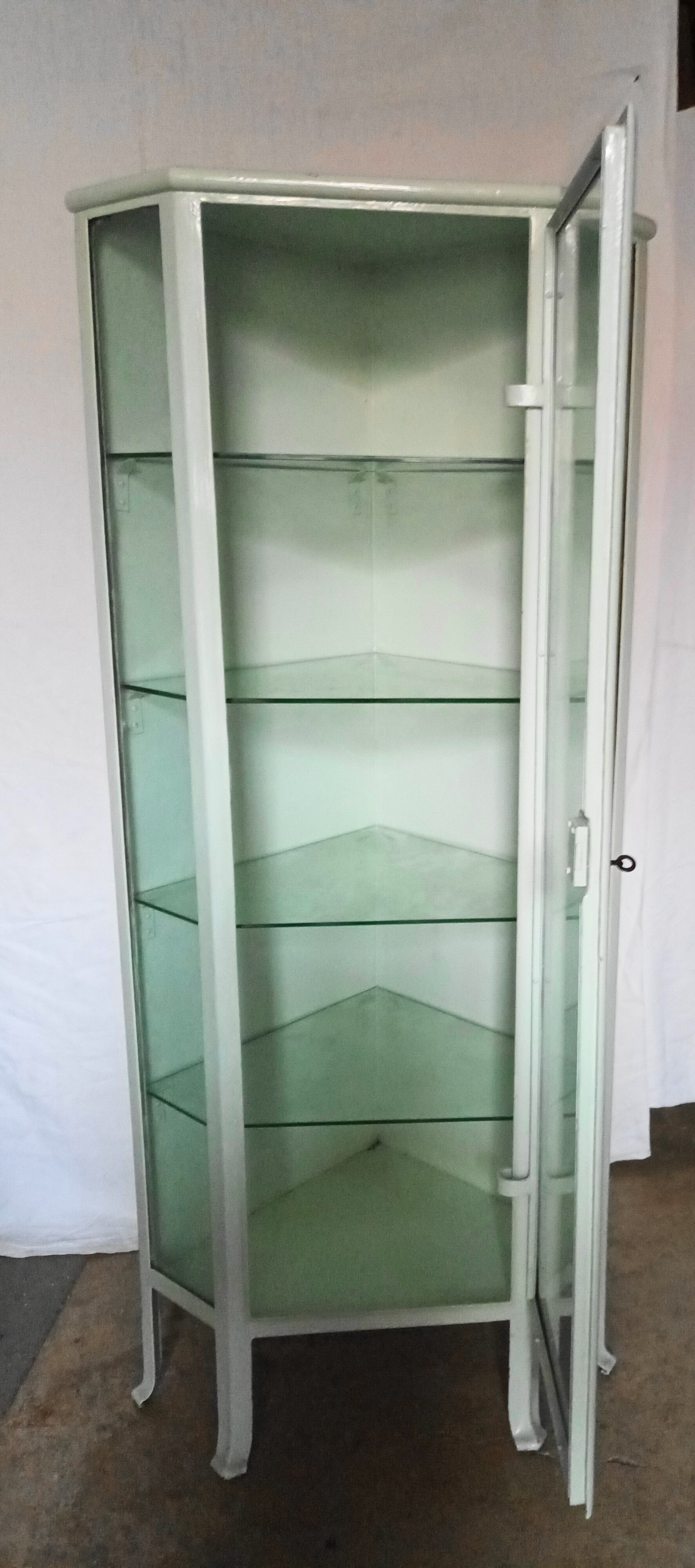 Painted metal ophthalmologist's corner display case, early 20th century