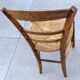 4 mismatched wood and straw chairs
