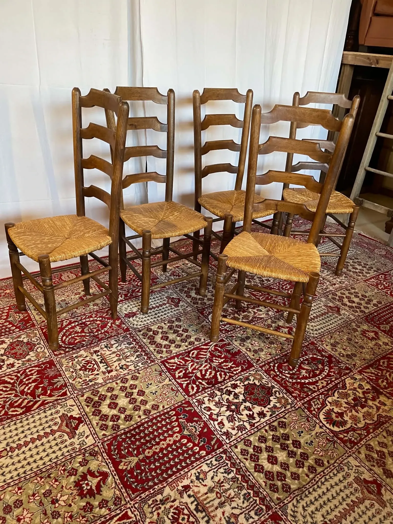 Set of 5 antique solid oak chairs with straw seats.