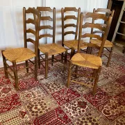Set of 5 antique solid oak chairs with straw seats.