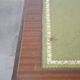 English style chesterfield desk with patina and a green leather top