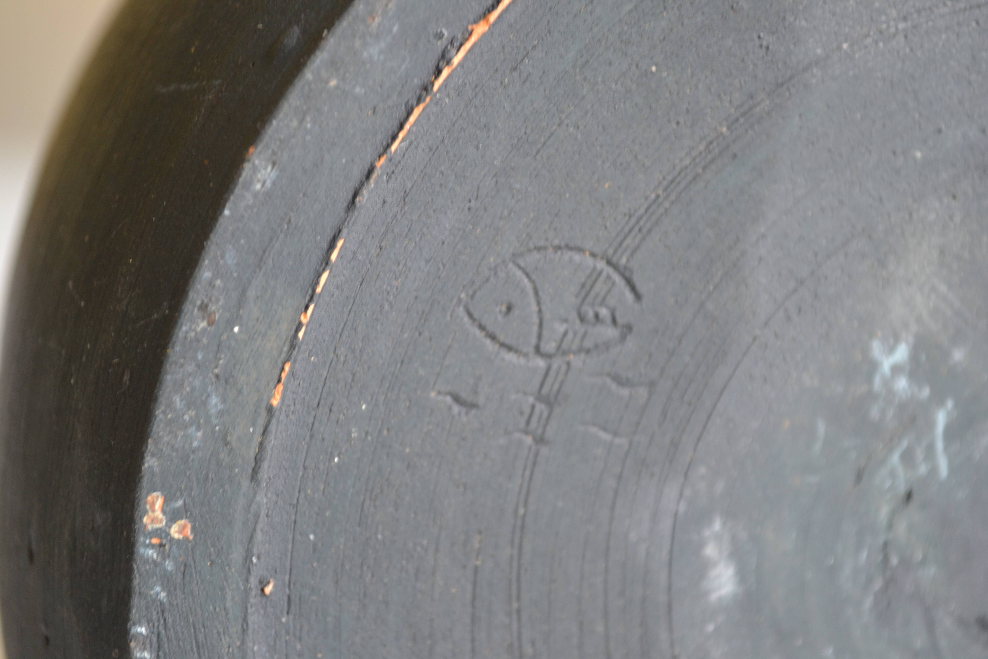 Ceramic cache pot or pocket emptying dish with a signature fish to identify.