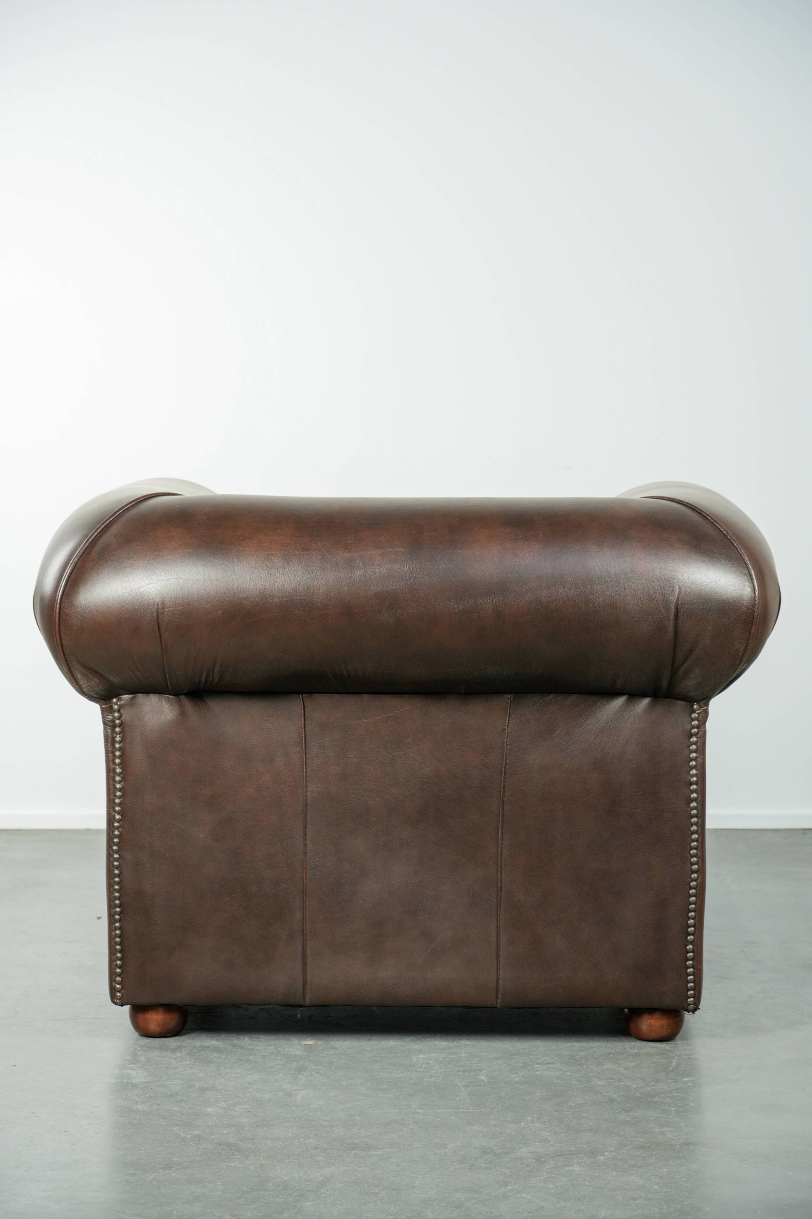 Set of a smooth chesterfield sofa and armchair with a timeless English look