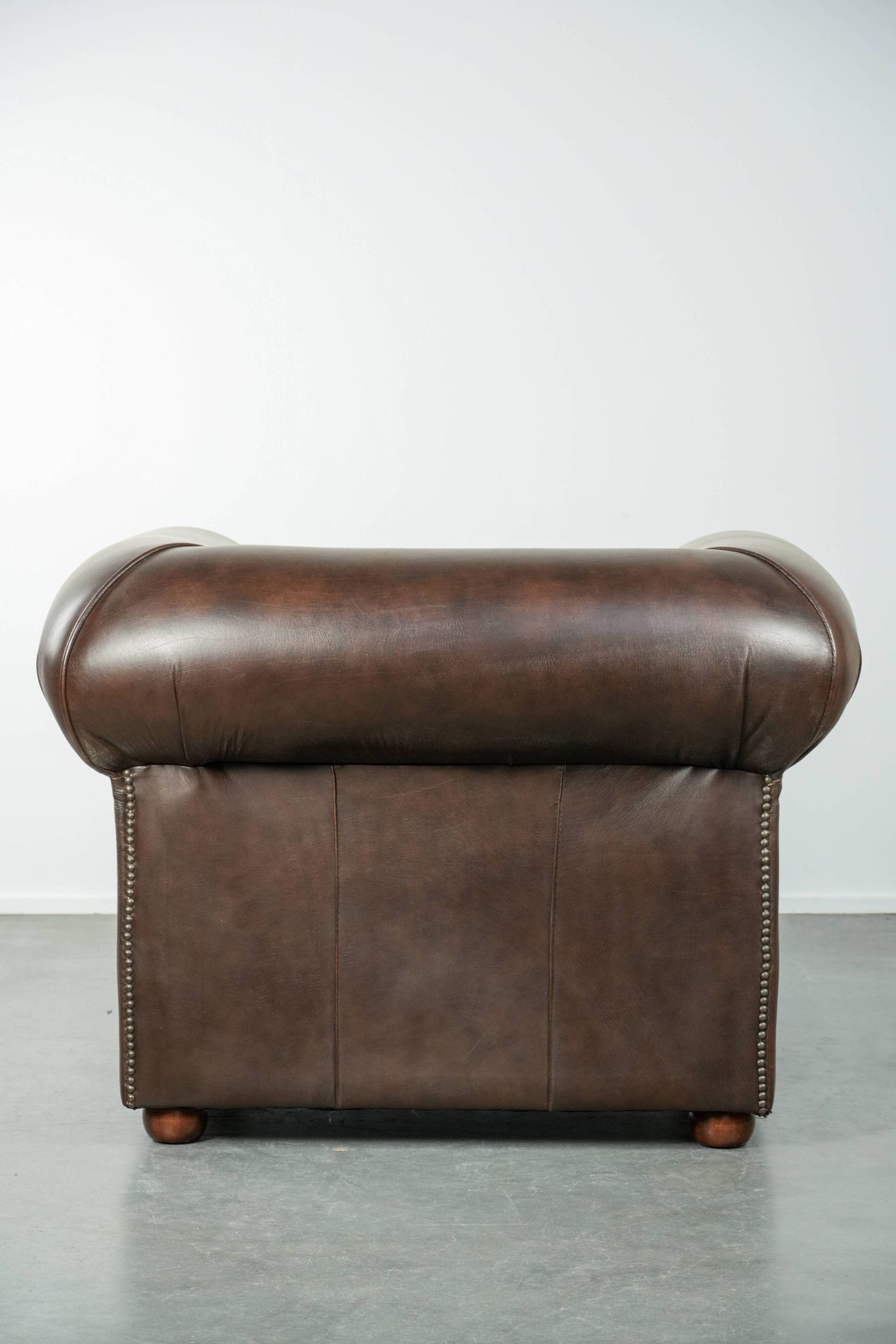 Set of a smooth chesterfield sofa and armchair with a timeless English look