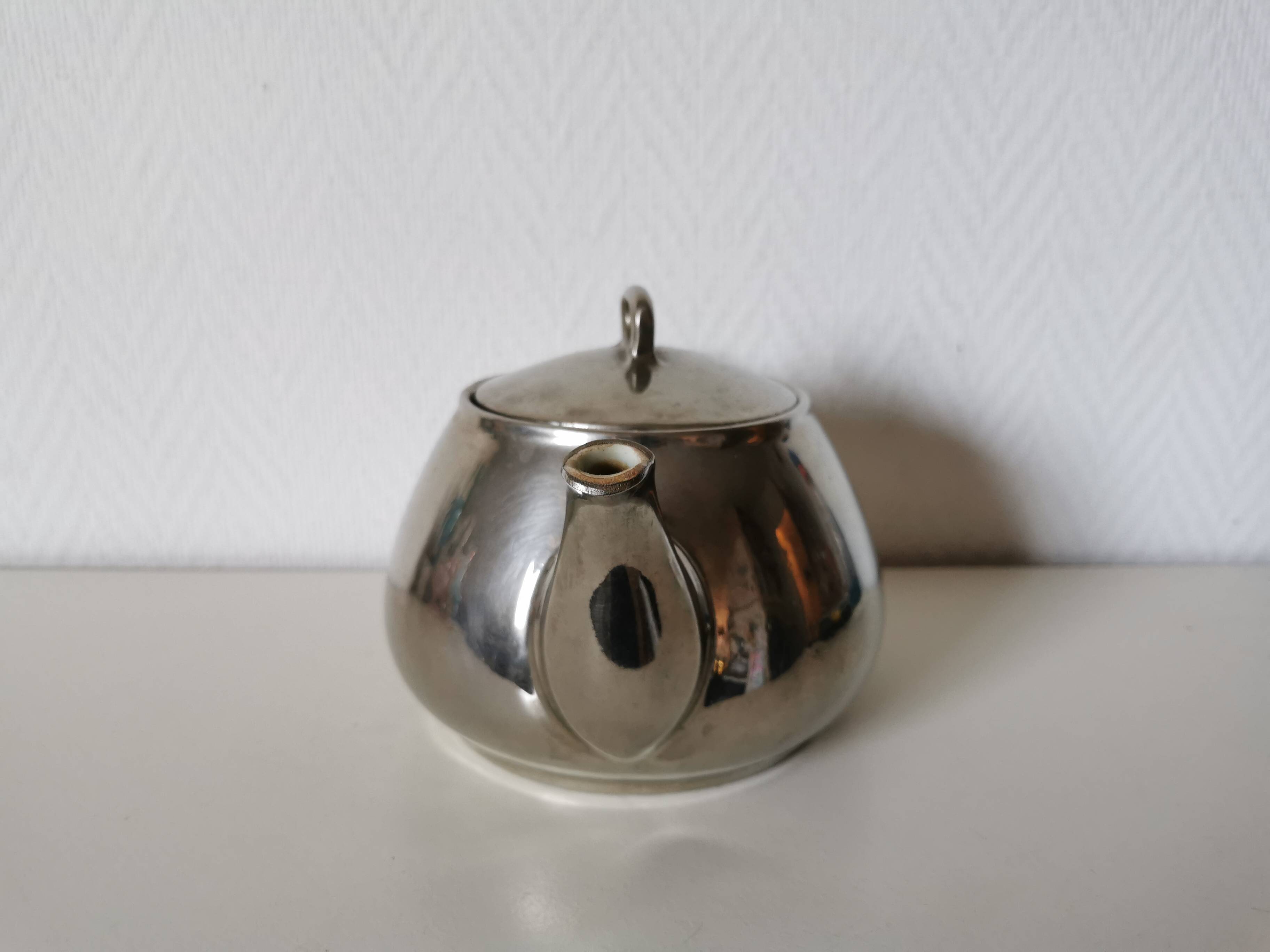 vintage teapot covered with silver metal
