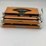 WE typewriter orange