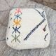Berber floor pouf: Handwoven Moroccan wool cushion.