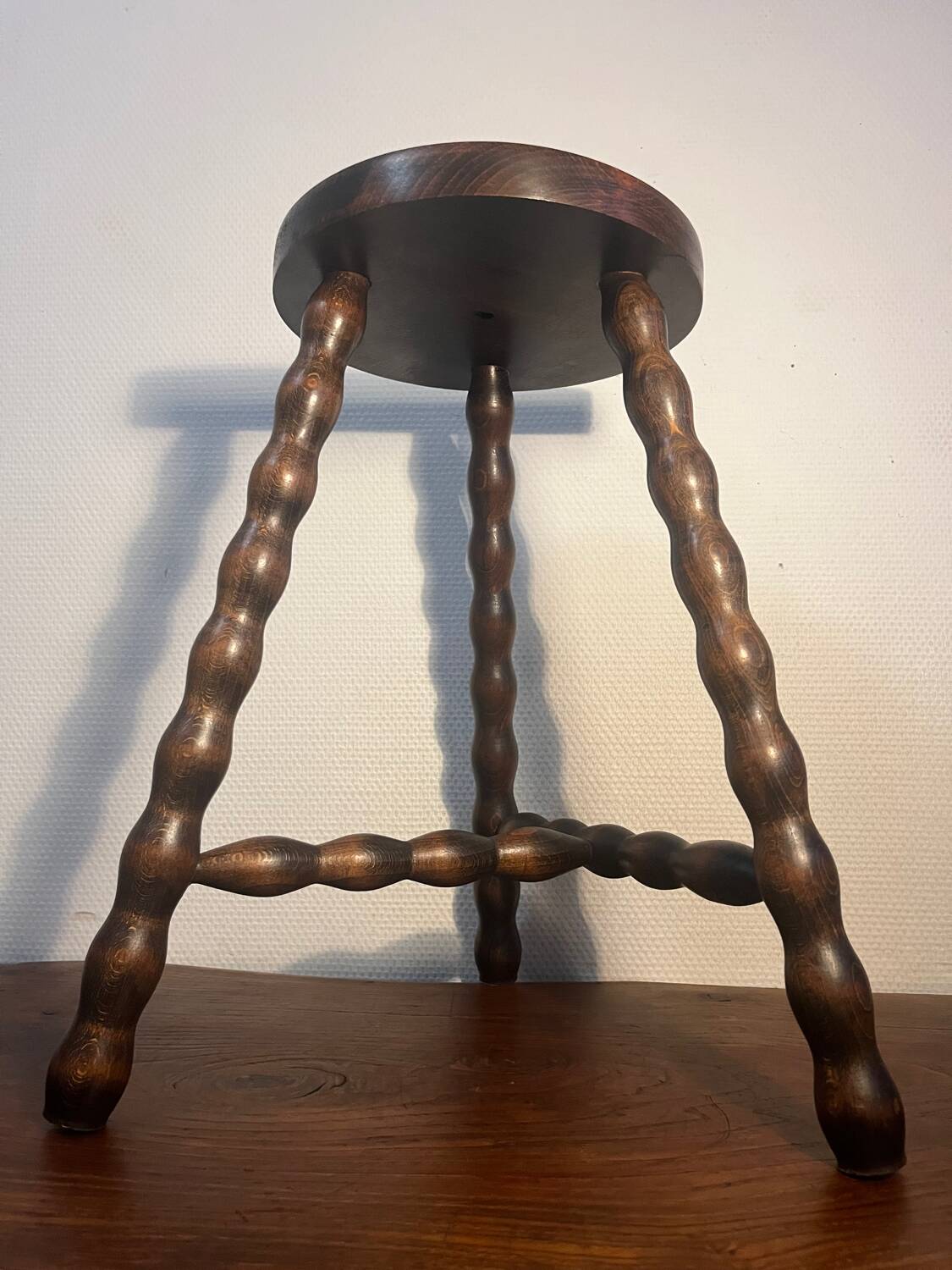 Round tripod stool with turned wooden legs