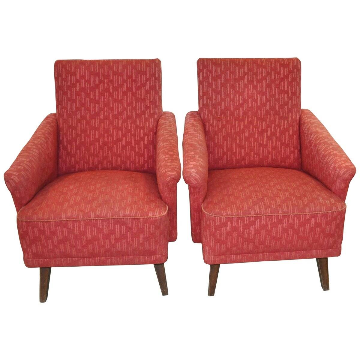 Pair of Mid-Century armchairs in red and brown fabric with dark wooden legs.