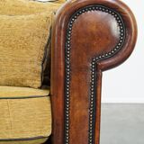 Luxurious and spacious two-seater sheepskin sofa of top quality with fabric cushions