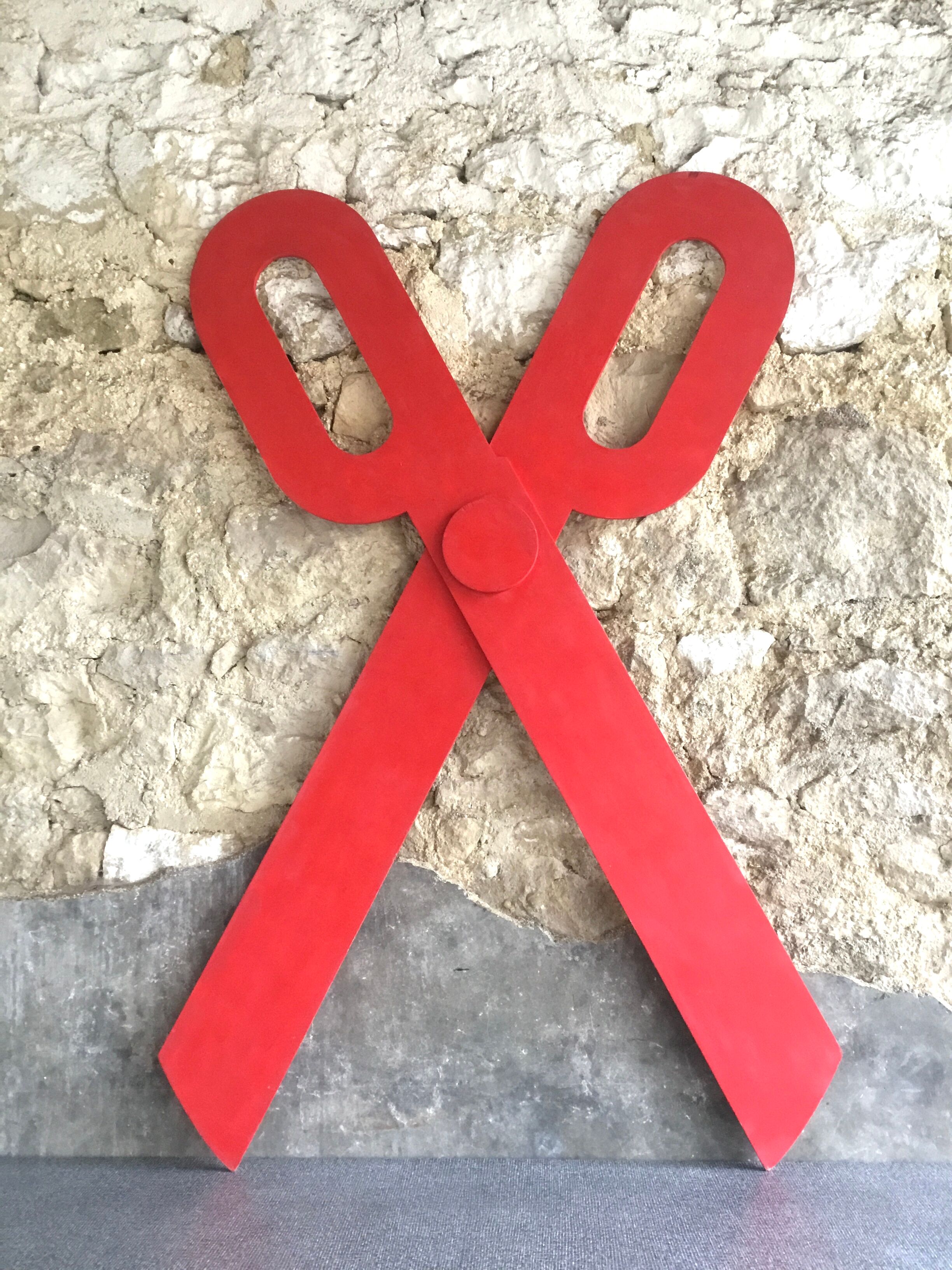 Wooden sign in the shape of scissors