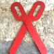 Wooden sign in the shape of scissors