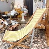 Vintage folding deckchair with yellow striped canvas