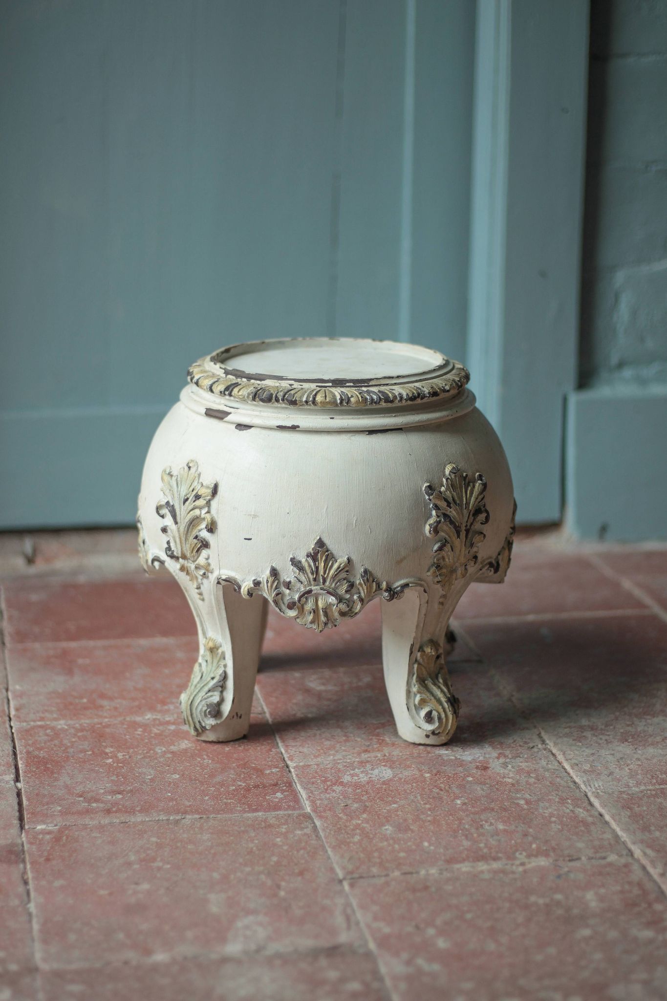 Solid wood plant stand with Louis XV style palm leaf motifs.