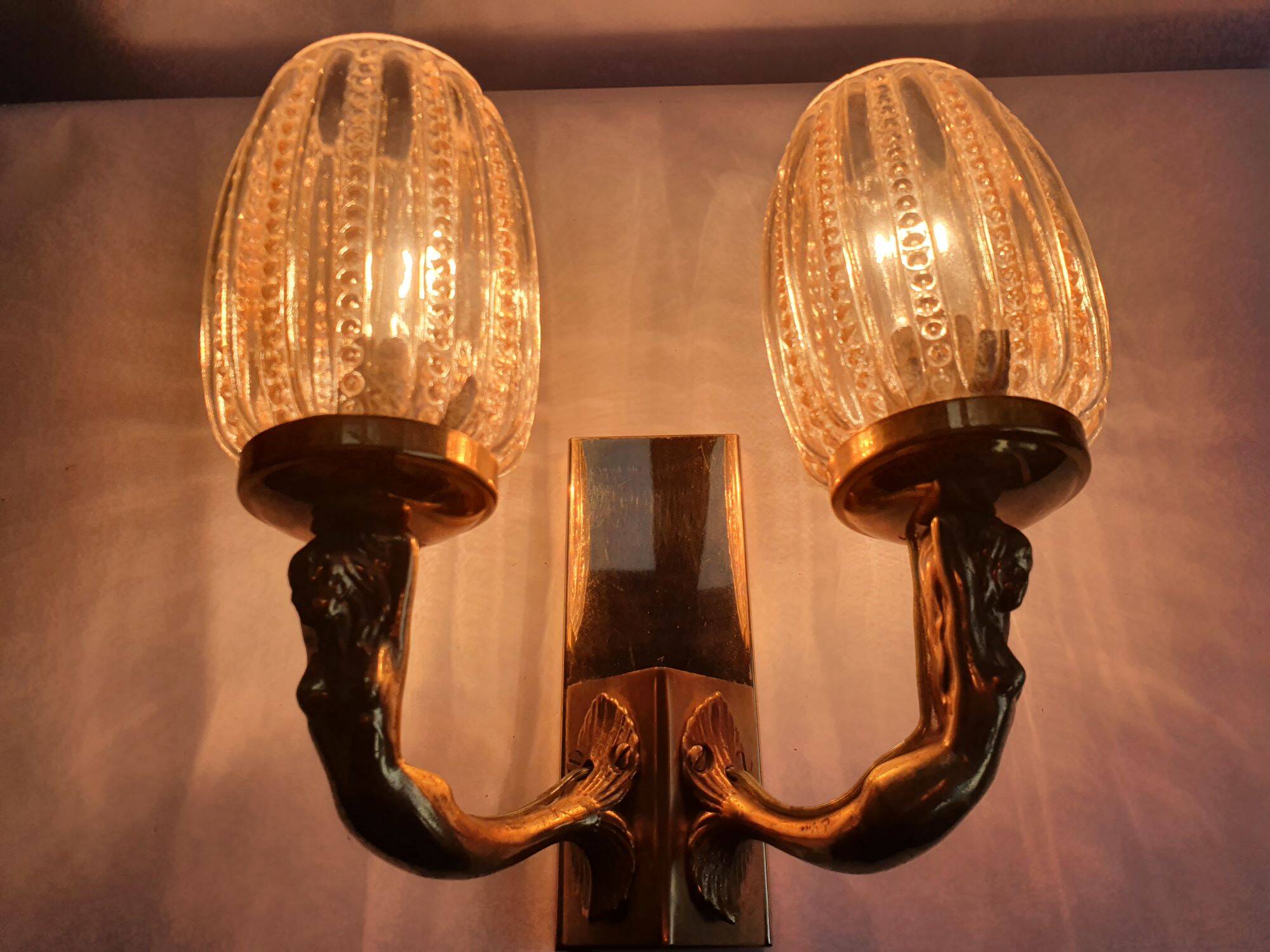 Golden bronze wall lamp with mermaids for an old bathroom.