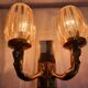Golden bronze wall lamp with mermaids for an old bathroom.