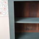 Wood and khaki green bookcase