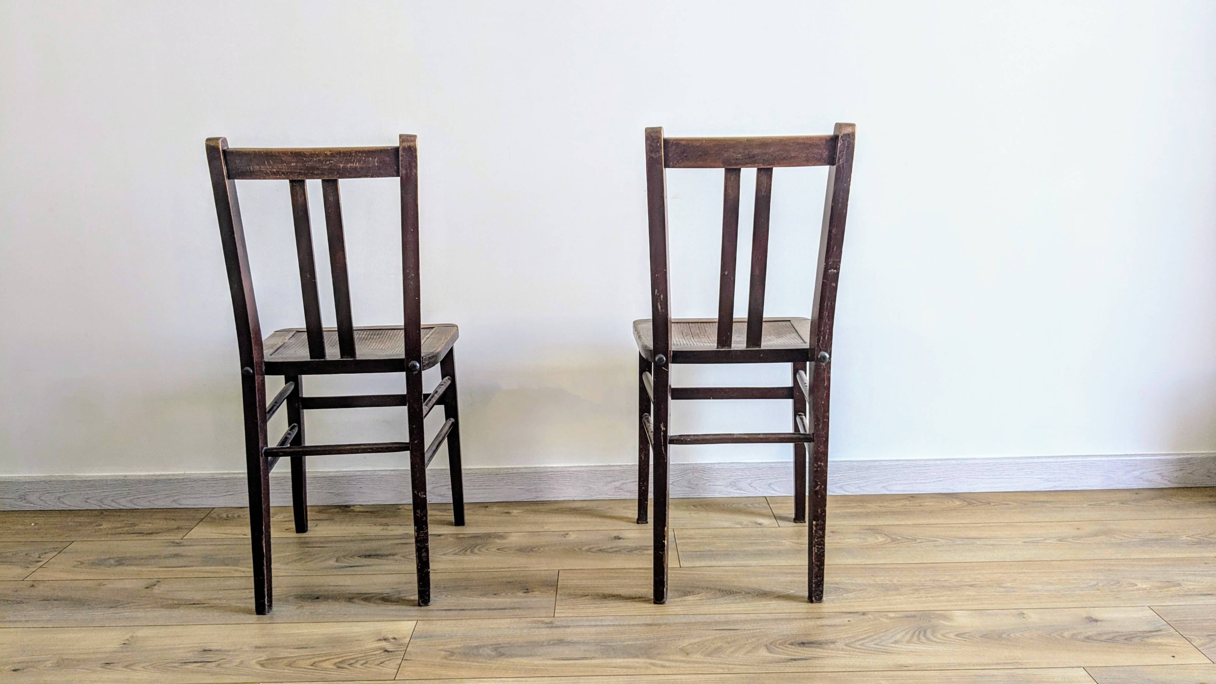 Pair of 1930s bistro chairs with patinated wood.