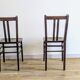 Pair of 1930s bistro chairs with patinated wood.