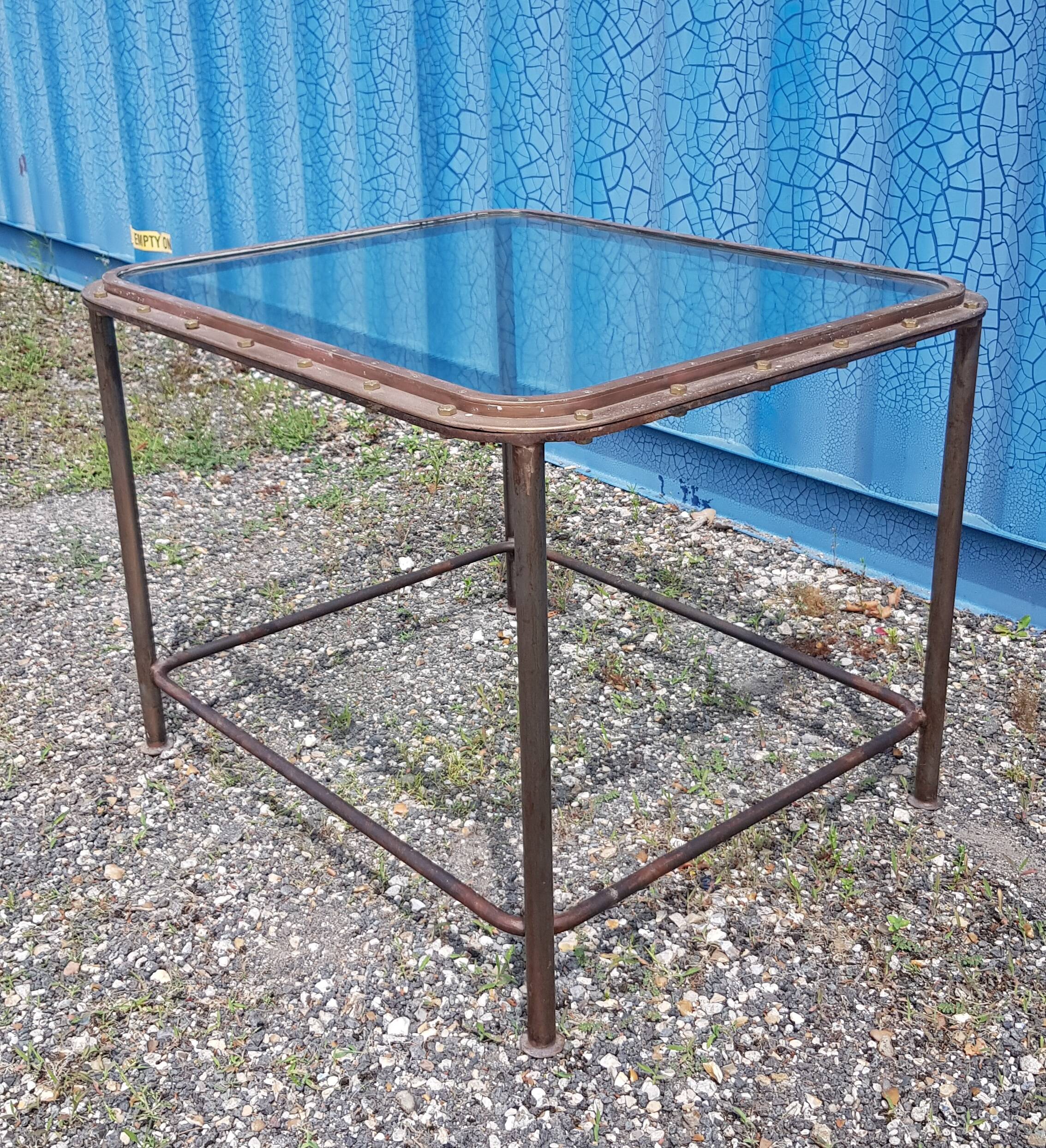 Table with an old ship porthole in brass and a metal base / 100 x 85 x 76 cm