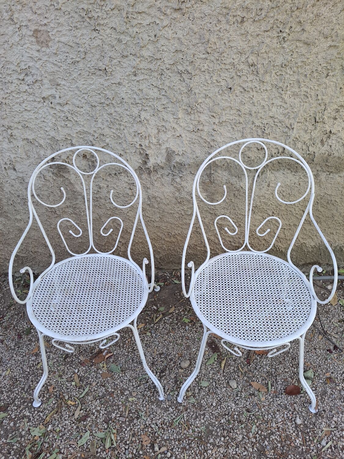 Pair of old white iron armchairs