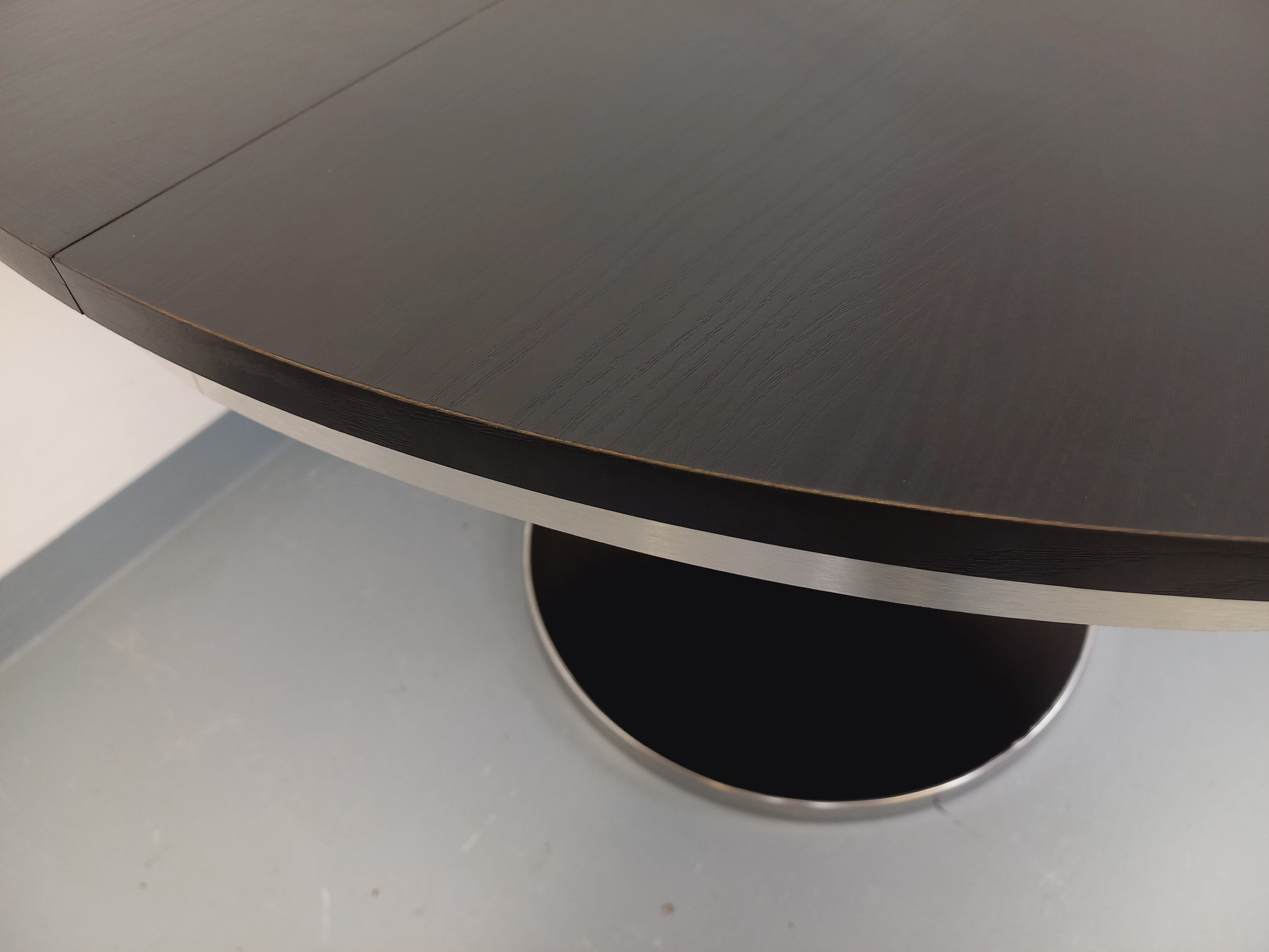 Vintage dining table in melamine with a black wood effect and chrome metal.