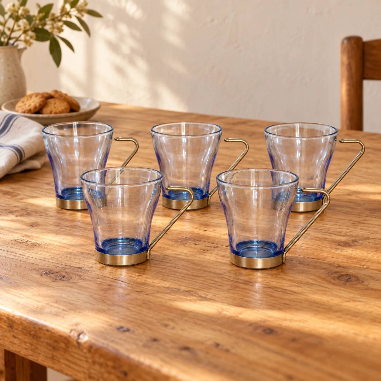 Set of 5 vintage blue-tinted glass cups with metal holders.