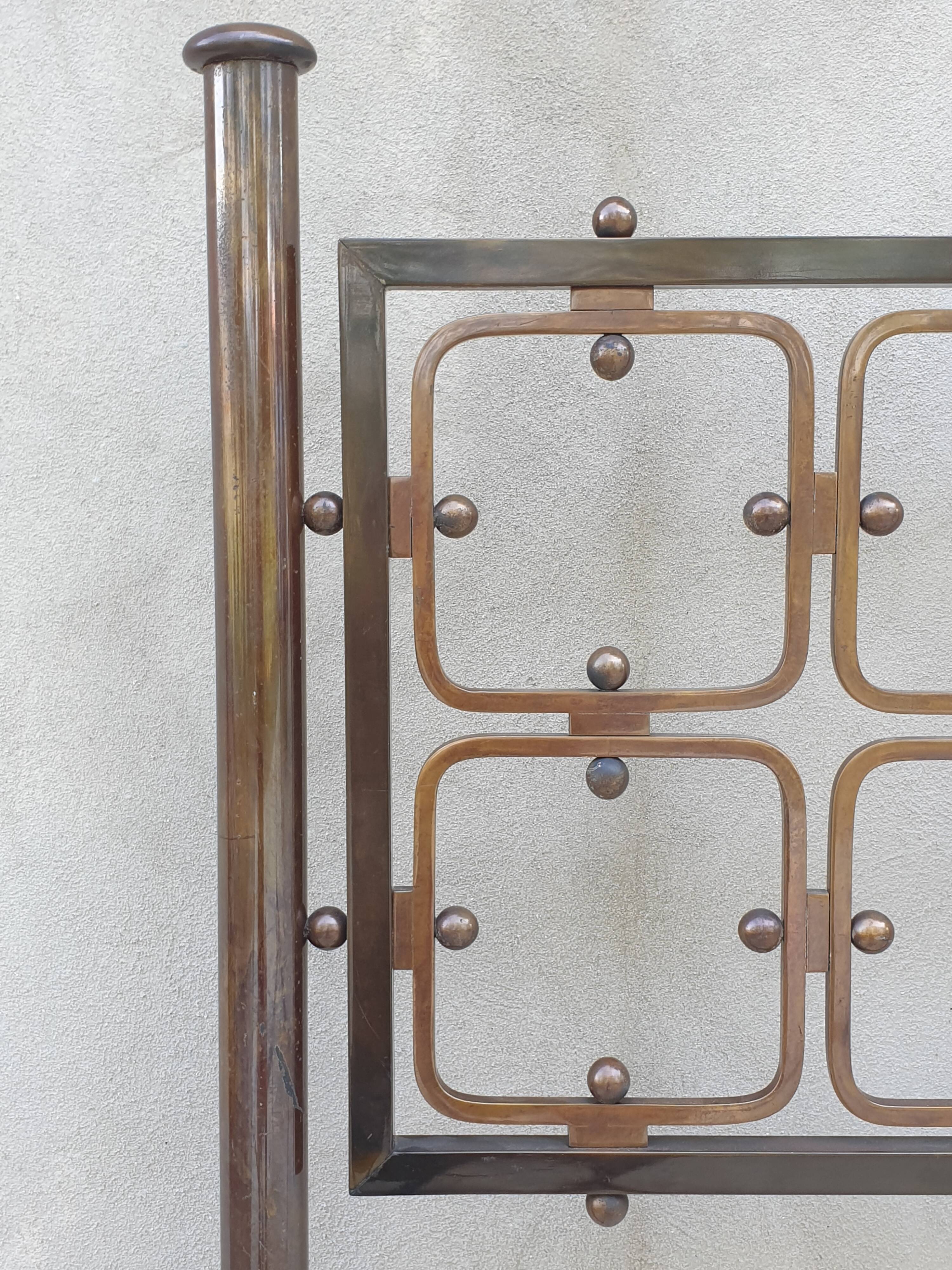 Double bed in burnished brass