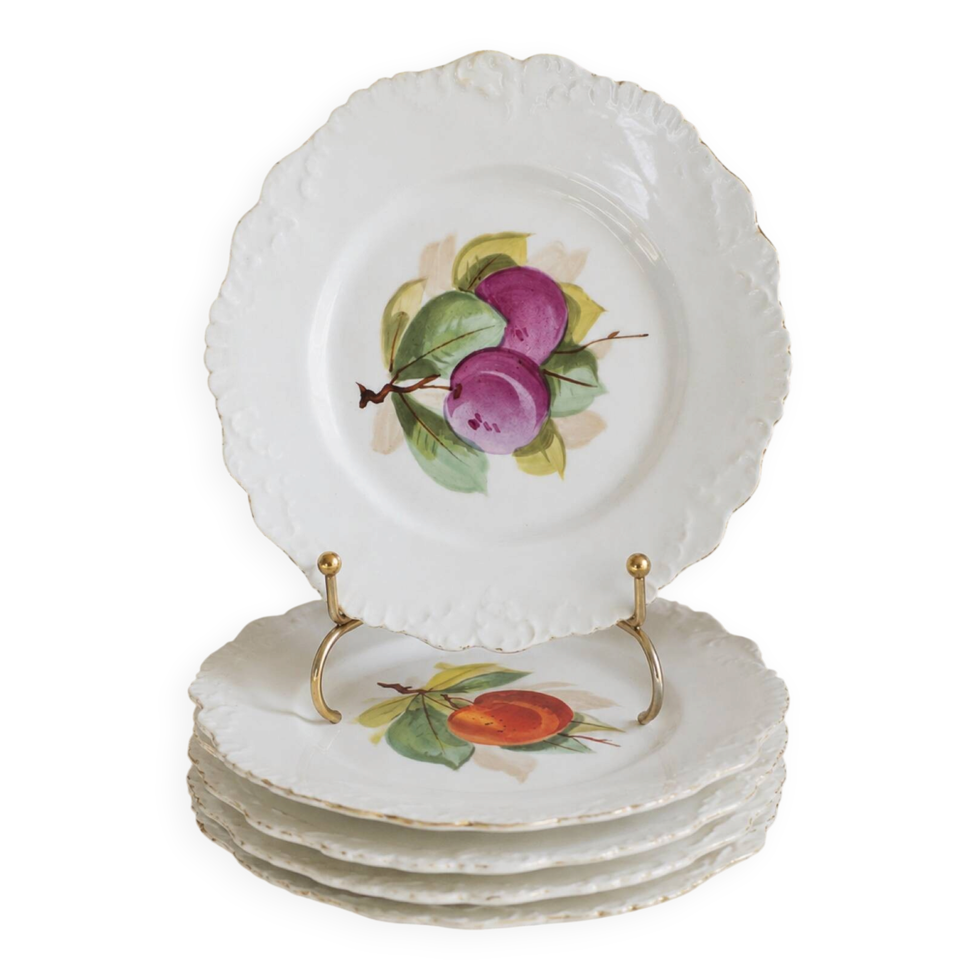 Antique plates from the late 19th century with scalloped edges and fruit decoration.