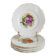Antique plates from the late 19th century with scalloped edges and fruit decoration.