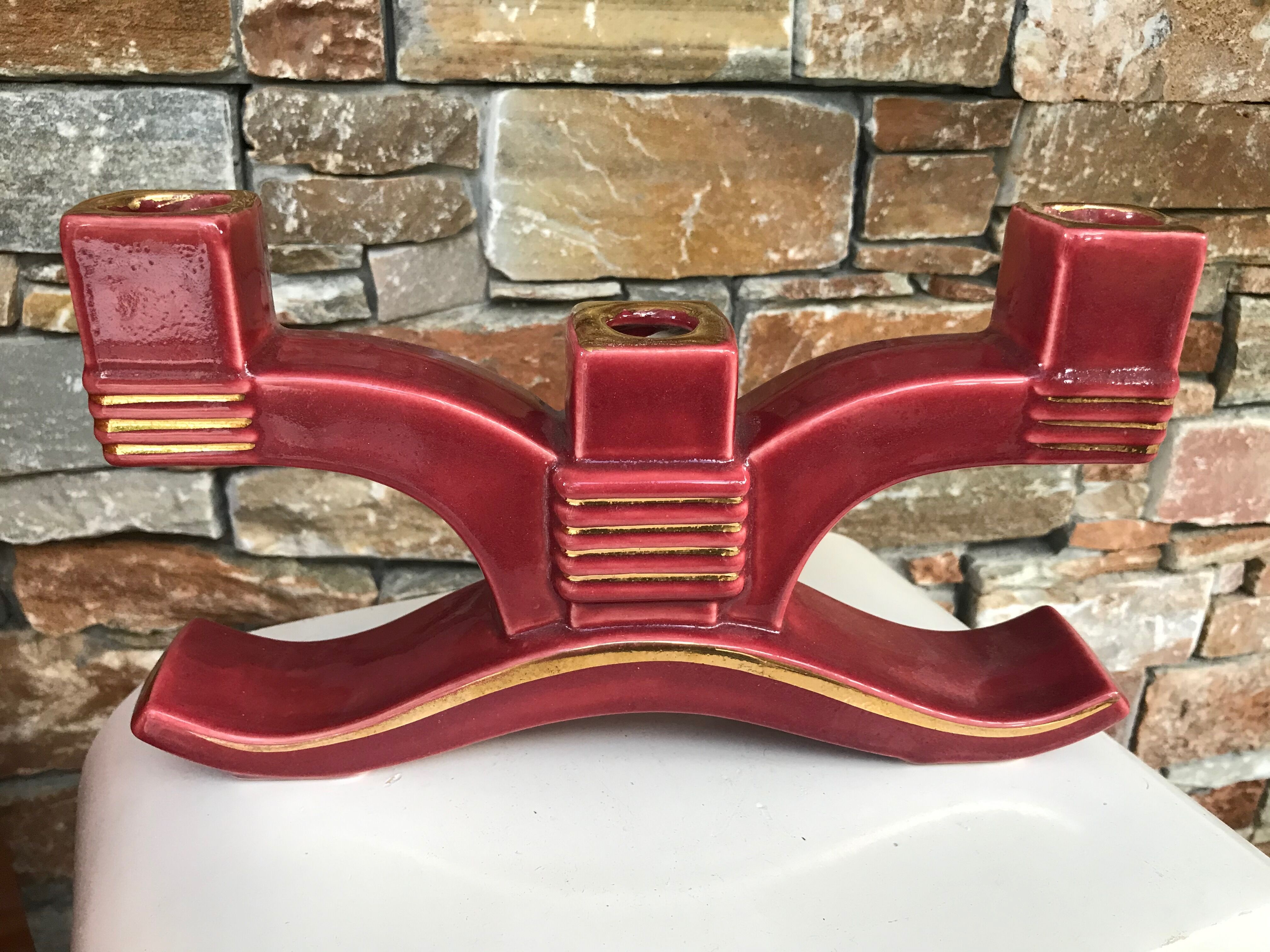 Former pair of burgundy ceramic candlesticks