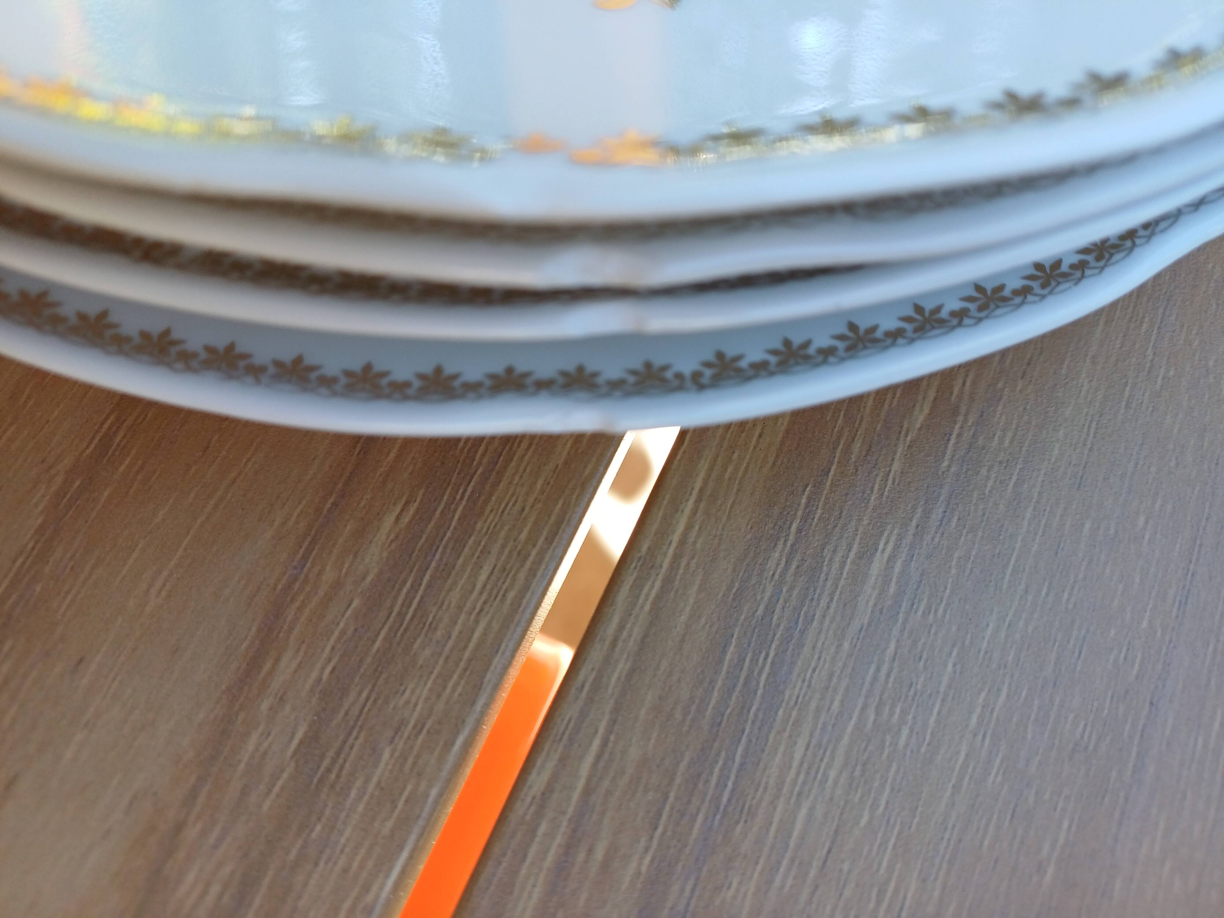 A lot of old white and gold porcelain plates T de F.